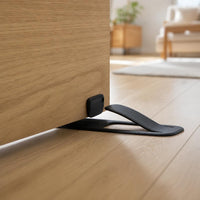 Door stopper holding a wooden door open