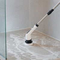 Electric spin scrubber cleaning the shower floor and grout